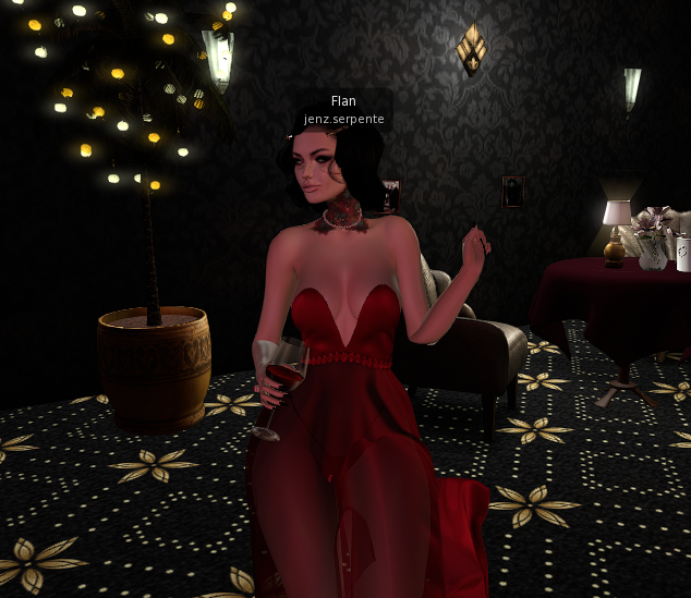 Flan, the OnlyFlans spokesmodel, in a red gown with a glass of wine